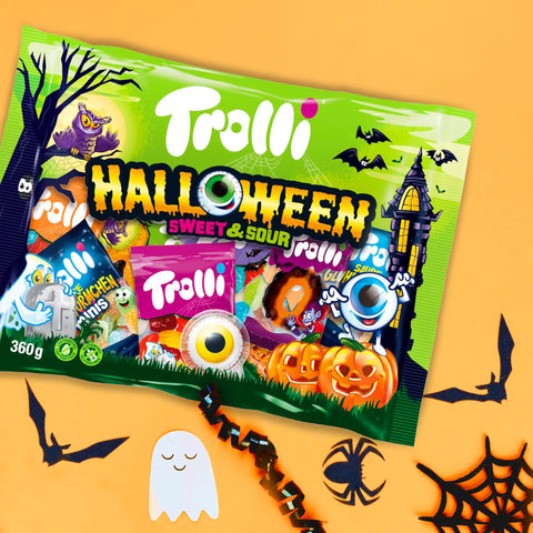 Trolli Halloween Süßigkeitenbeutel mit Kürbissen, Spinnen und Halloween-Motiven auf orangem Hintergrund